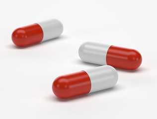 Three capsules on white background