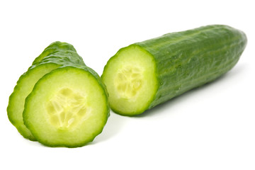 Cucumber and slices  over a white background