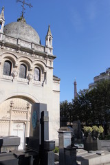 Fototapeta na wymiar la tour Eiffel derrière un caveau du cimetière de Passy à Paris 