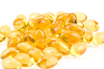 Transparent gold fish oil pills close-up