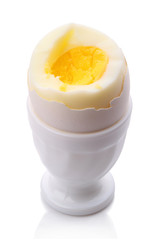 Single egg in cup on white