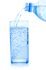 Stream ofwater fallind in glass from bottle