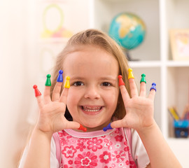 Little girl playing with game pieces