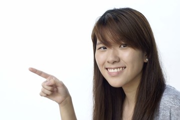 Happy asian teen lady pointing left