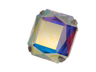 Faceted stone with many color refractions on white background