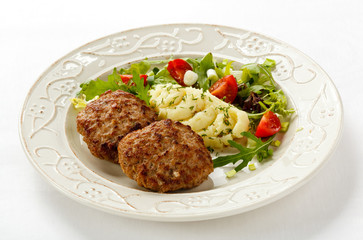 Fried steaks with mashed potatoes and vegetable salad