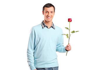 Young smiling man holding a rose flower