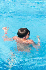 teenager swims in pool