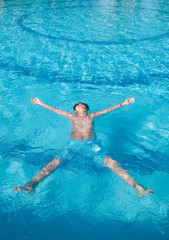 teenager swims in pool