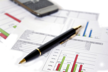 pen cell phone and financial diagrams