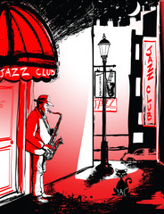 saxophone player in a street at night