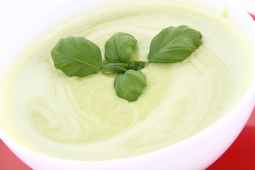 Pea and mozzarella soup decorated with basil