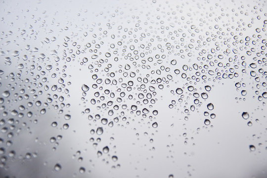 Water droplets on the grey glass