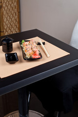 Naklejka na ściany i meble Table place setting with sushi roll