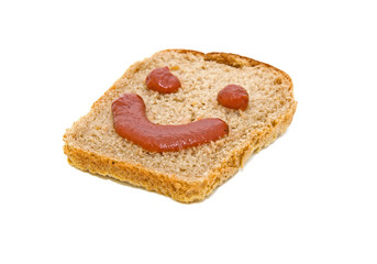 smiley face on a piece of black bread