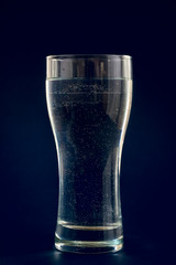 water in glass on blue background