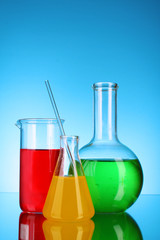 Laboratory glassware on blue background