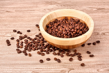 Plate with coffee beans on wooden table