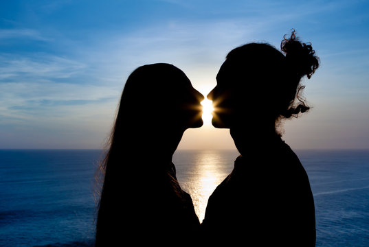 Silhouette of a young couple at sunset
