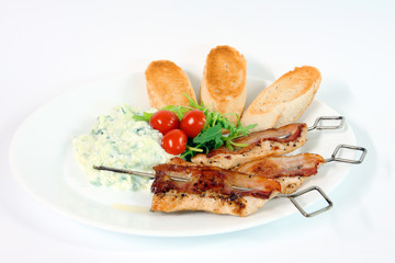 Greek food - tzatziki, chicken souvlaki with bacon and baguette