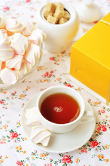 Cup of  tea with marshmallows and cake