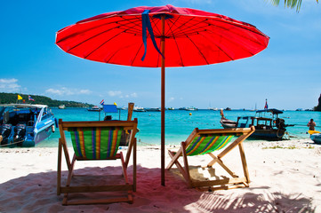 Beach chair and Long tailed boat  at Phi-phi island in Thailand