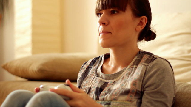 Young exciting woman playing videogames, steadicam shot