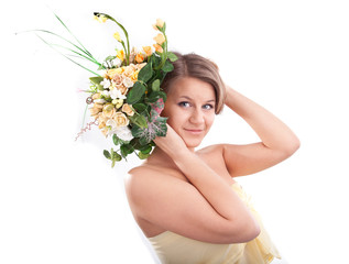 Young woman holding flowers near head