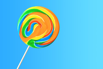 Colorful lollipop on bright blue background