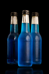 Blue bottle isolated on black background.