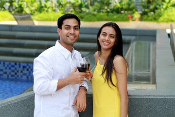 Young romantic couple celebrating with wine.