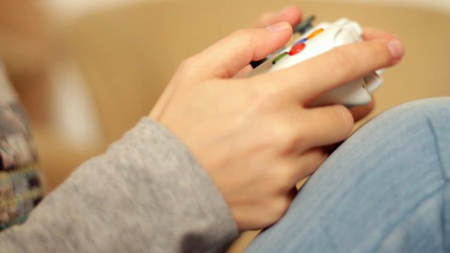 Female hands playing videogames