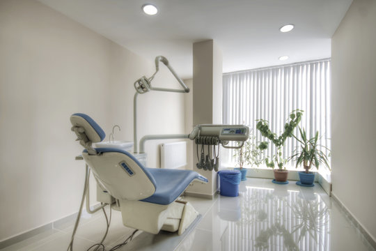 Dental instruments and modern Dentist's chair in a medical room