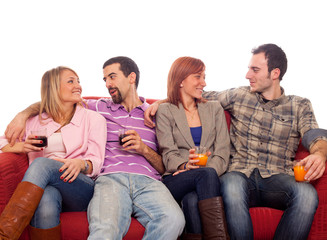 Fototapeta premium Young Group Sitting on Sofa and Drinking