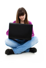 Naklejka premium Happy smiling girl working on laptop isolated on white