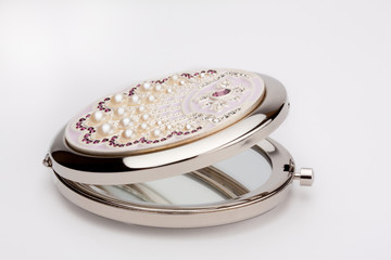 Round pocket mirror with pearls on white background - 30961569