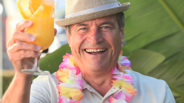 Middle aged man celebrating with a cocktail
