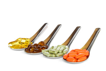 spoon with colorful vitamin medicine pills