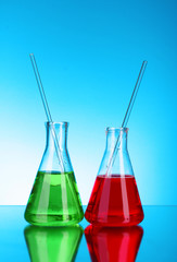 Laboratory glassware on blue background