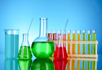 Laboratory glassware on blue background