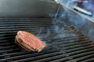 closeup fresh beefsteak frying on commercial kithen grill