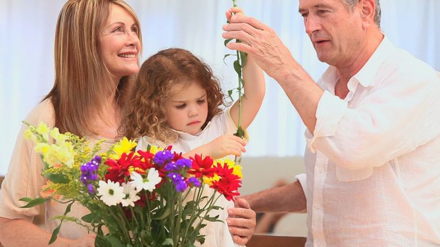 Family putting on flowers in a vase