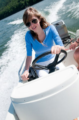 Young girl driving motorboat