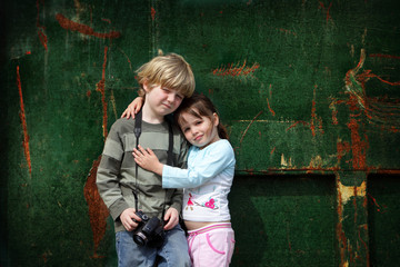 Fototapeta na wymiar Young brother and sister pose for a photograph with their camera