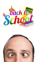 Young man with BACK TO SCHOOL sign over his head