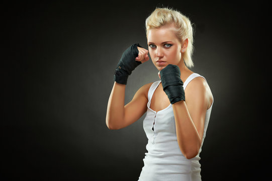 Beautiful boxer girl with black bandage on hands