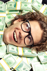 Curly man lying on money