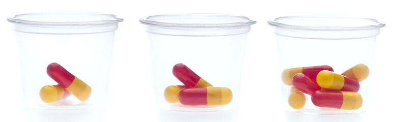 Three containers with different amount of pills