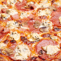 Pizza with cheese, salami and mushrooms