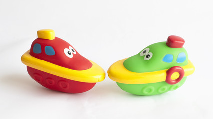 Childs toy boats for the bath red and green on white background
